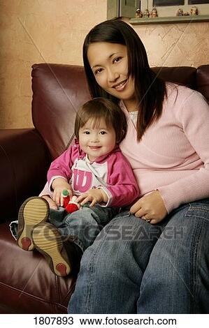 Japanese mother and daughter on couch View Large Photo Image Stock Image - Japanese mother and daughter on couch . Fotosearch