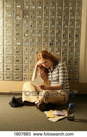 Stock Image - Lady opening mail at mailboxes. Fotosearch