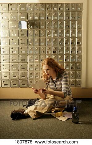 Lady opening mail at post office boxes View Large Photo Image Stock Photo - Lady opening mail at post office boxes. Fotosearch