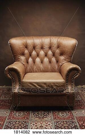 Stock Image - Leather armchair with carpet. Fotosearch