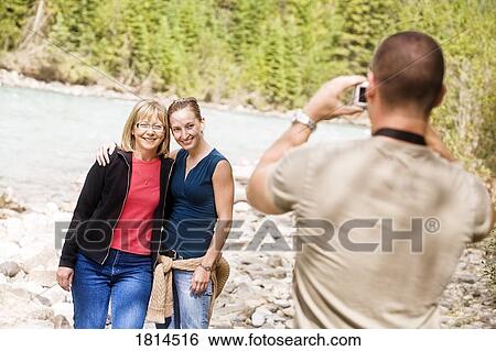 Man taking photo of women View Large Photo Image Stock Photograph - Man taking photo of women. Fotosearch