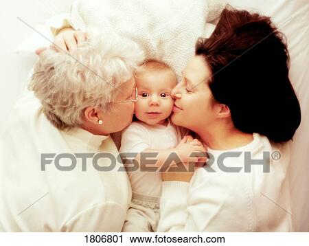 Mother and grandmother kissing baby View Large Photo Image Stock Image - Mother and grandmother kissing baby. Fotosearch
