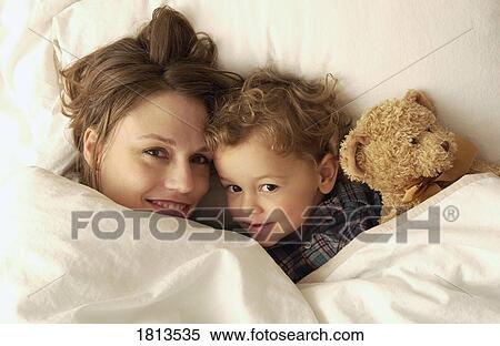 Mother and son laying in bed View Large Photo Image Stock Photography - Mother and son laying in bed. Fotosearch
