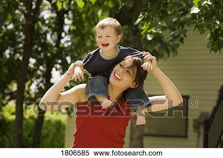 Mother with son on her shoulders View Large Photo Image Stock Photography - Mother with son on her shoulders. Fotosearch