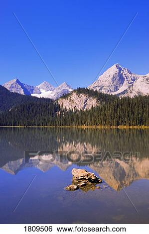 Stock Photograph - Mountain lake reflections, Elk Lakes Provincial Park. Fotosearch
