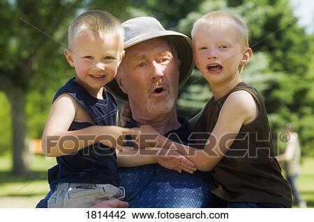 Stock Image - Portrait of a grandfather with grandsons. Fotosearch