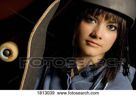 Portrait of woman holding skateboard View Large Photo Image Stock Photo - Portrait of woman holding skateboard. Fotosearch