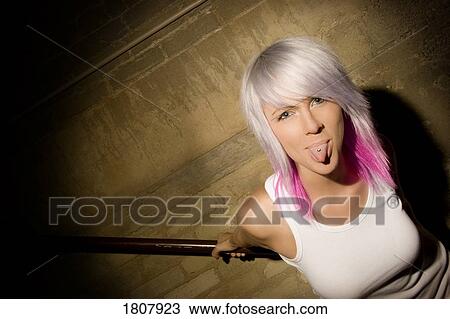 Portrait of woman showing tongue piercing View Large Photo Image Stock Image - Portrait of woman showing tongue piercing. Fotosearch