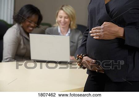 Pregnant business woman in the office View Large Photo Image Stock Image - Pregnant business woman in the office. Fotosearch