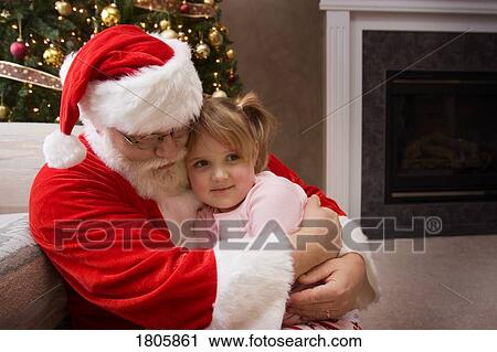 Santa Claus hugging a little girl View Large Photo Image Stock Image - Santa Claus hugging a little girl. Fotosearch