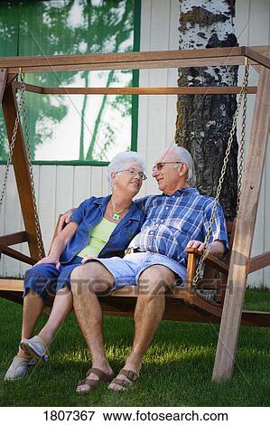 Senior couple on swing View Large Photo Image Stock Photo - Senior couple on swing. Fotosearch