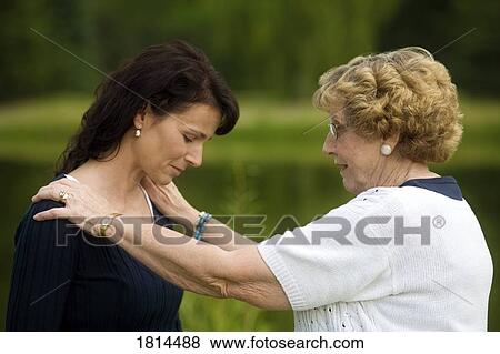 Senior woman consoling a younger woman View Large Photo Image Stock Photo - Senior woman consoling a younger woman. Fotosearch