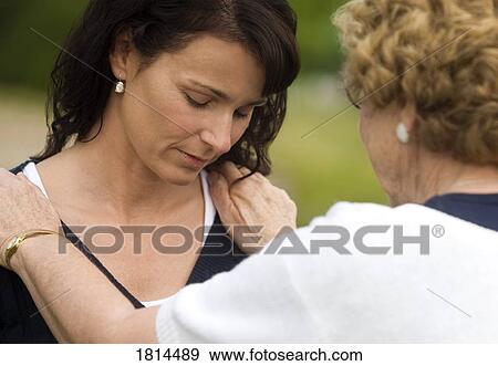 Senior woman consoling young woman View Large Photo Image Stock Photo - Senior woman consoling young woman. Fotosearch