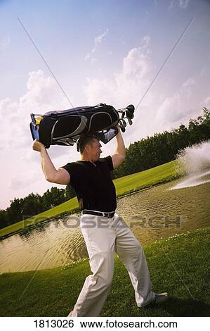 Stock Photograph - Side view of a frustrated golfer. Fotosearch