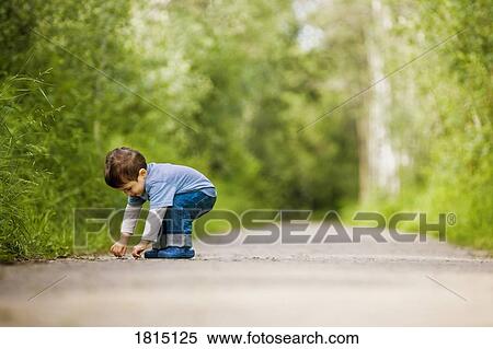 Stock Photography - Side view of boy on path. Fotosearch