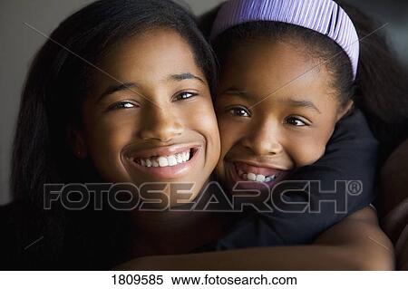 Sisters hugging View Large Photo Image Stock Photography - Sisters hugging. Fotosearch
