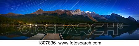 Stock Photograph - Starry night panoramic of mountains and lake, Jasper National Park, Alberta, Canada. Fotosearch