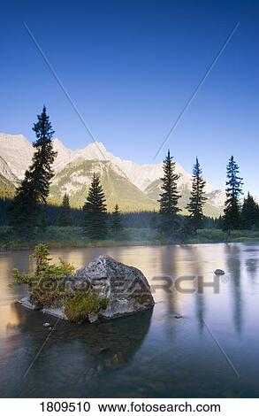 Stock Image - Sunrise and early morning mist on mountain river. Fotosearch