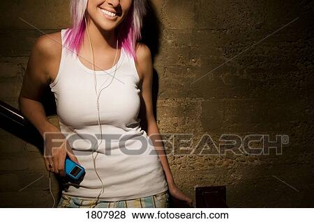 Teenager listening to personal music player View Large Photo Image Stock Photo - Teenager listening to personal music player. Fotosearch
