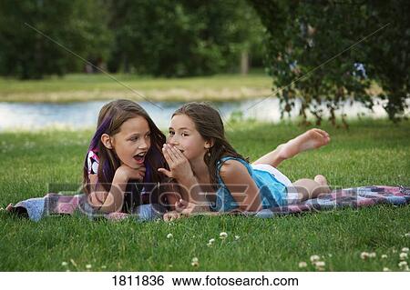 Telling secrets View Large Photo Image Stock Photograph - Telling secrets. Fotosearch