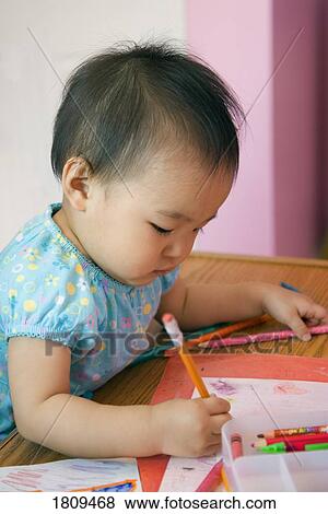 Stock Photo - Toddler drawing with a pencil. Fotosearch