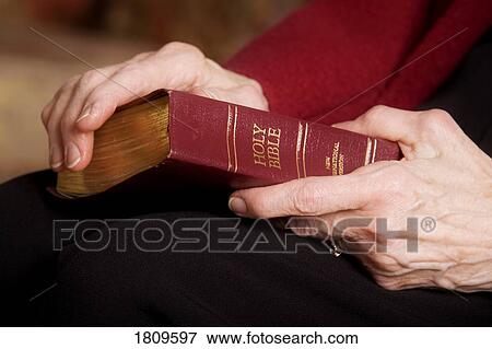 Woman holding a Bible View Large Photo Image Stock Photo - Woman holding a Bible. Fotosearch