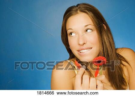 Stock Photograph - Woman holding flower. Fotosearch