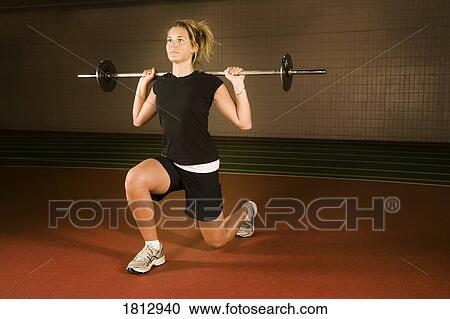 Stock Image - Woman lifting weights. Fotosearch