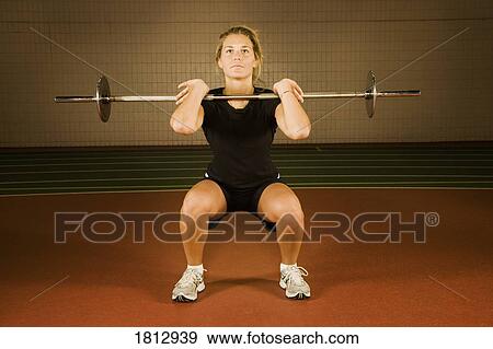 Woman lifting weights View Large Photo Image Stock Photo - Woman lifting weights. Fotosearch