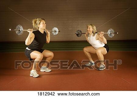 Stock Image - Women lifting weights. Fotosearch