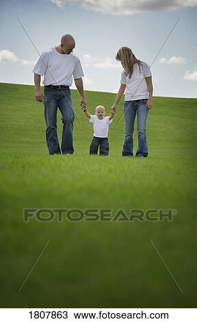 Young family walking together View Large Photo Image Stock Image - Young family walking together . Fotosearch
