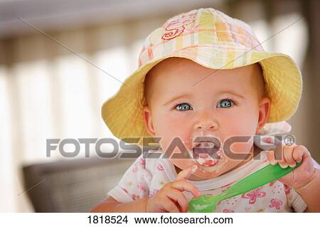 A baby with food on her face View Large Photo Image Picture - A baby with food on her face. Fotosearch