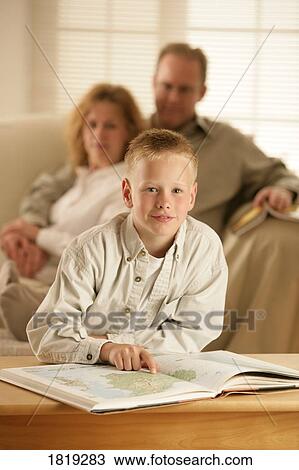 Stock Image - A boy with an atlas. Fotosearch