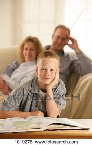 Stock Photo - A boy with an atlas. Fotosearch