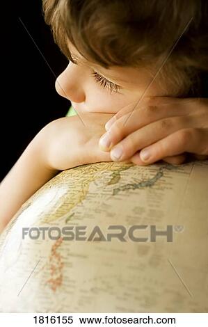 Stock Photography - A child leaning on a globe. Fotosearch