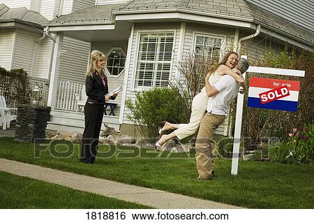 Stock Photograph - A couple with a realtor. Fotosearch
