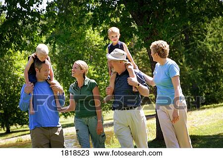 A family going for a walk in a park View Large Photo Image Stock Image - A family going for a walk in a park. Fotosearch