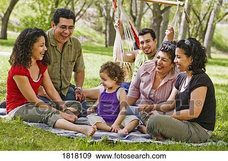 A family sitting in the park View Large Photo Image Stock Photo - A family sitting in the park. Fotosearch