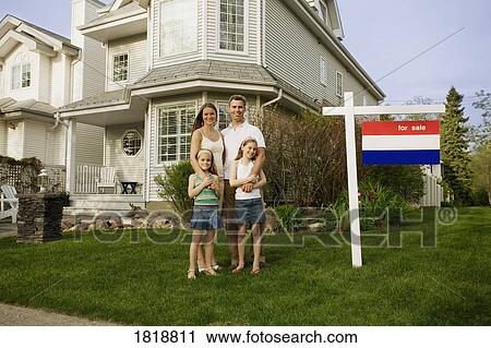 A family standing in front of a house for sale View Large Photo Image Stock Image - A family standing in front of a house for sale. Fotosearch