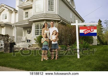 A family standing in front of a house with a sold sign View Large Photo Image Stock Image - A family standing in front of a house with a sold sign. Fotosearch