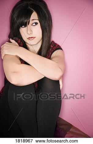 A female sitting in a corner View Large Photo Image Stock Photo - A female sitting in a corner. Fotosearch