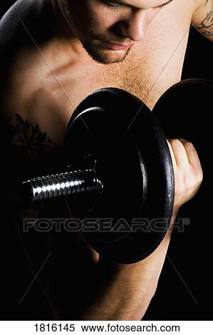 A man lifting weights View Large Photo Image Stock Photography - A man lifting weights. Fotosearch