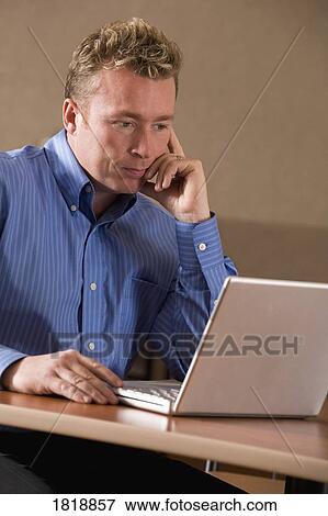 A man using a laptop View Large Photo Image Stock Photo - A man using a laptop. Fotosearch