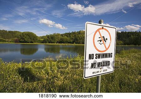 Stock Image - A sign beside a lake. Fotosearch