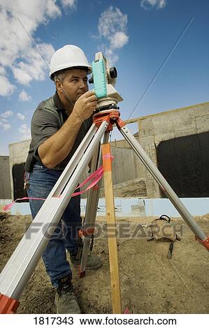 Stock Image - A surveyor at a construction site. Fotosearch