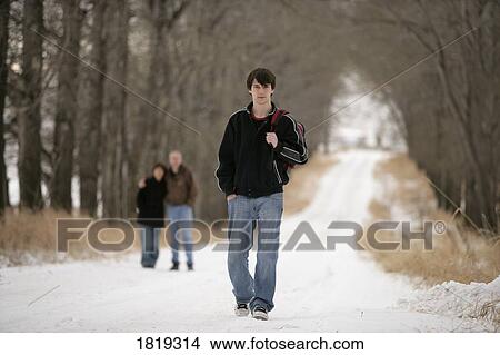 A teenage boy walking away from his parents View Large Photo Image Picture - A teenage boy walking away from his parents. Fotosearch