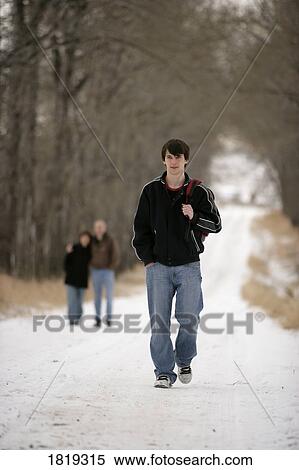 Stock Photography - A teenage boy walking away from his parents. Fotosearch