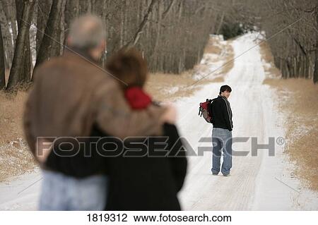 A teenage boy walking down a snow-covered path View Large Photo Image Stock Image - A teenage boy walking down a snow-covered path. Fotosearch