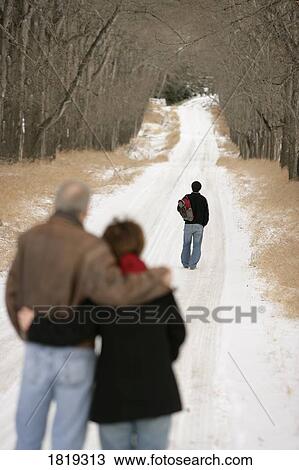 A teenage boy walking down a snow-covered path View Large Photo Image Stock Image - A teenage boy walking down a snow-covered path. Fotosearch