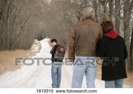 A teenage boy walking on a snow-covered path View Large Photo Image Stock Image - A teenage boy walking on a snow-covered path. Fotosearch
